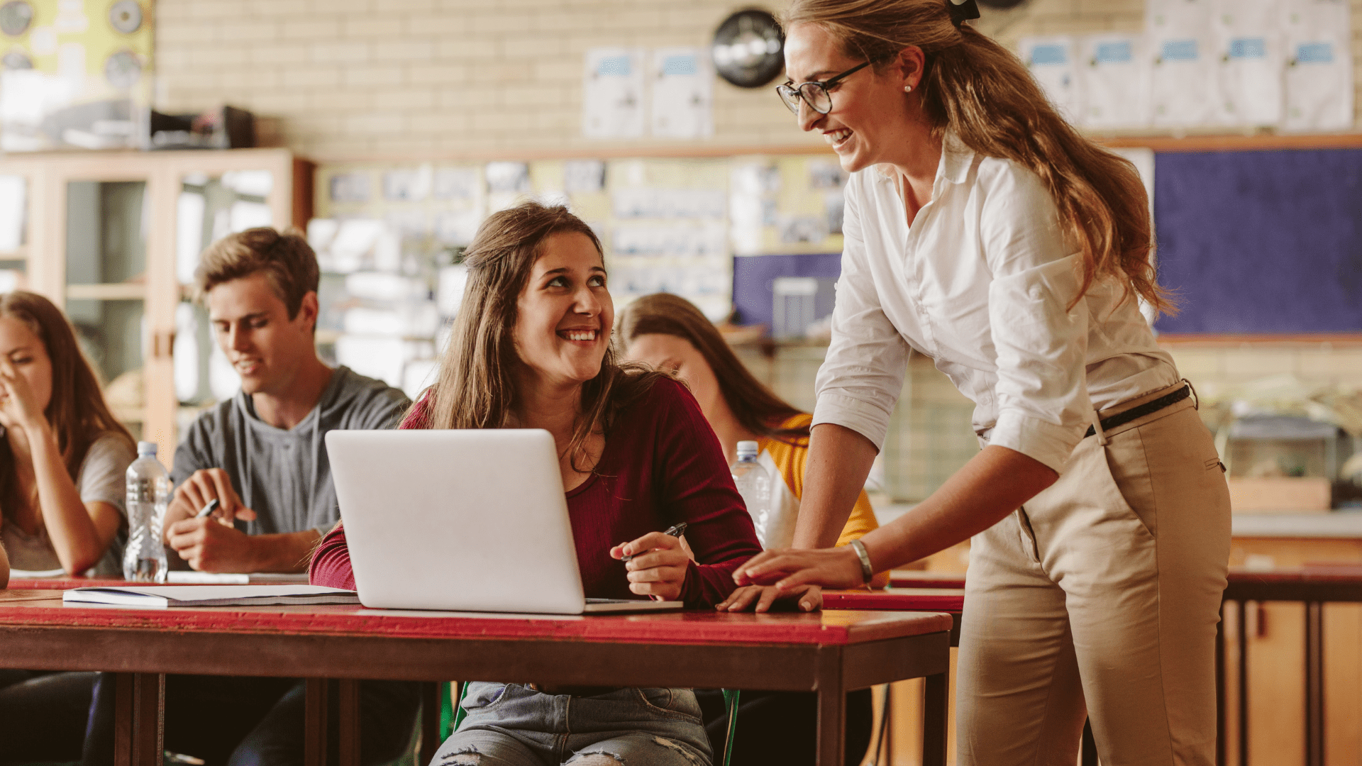 Website-Main-Slide2 Teacher helping a student